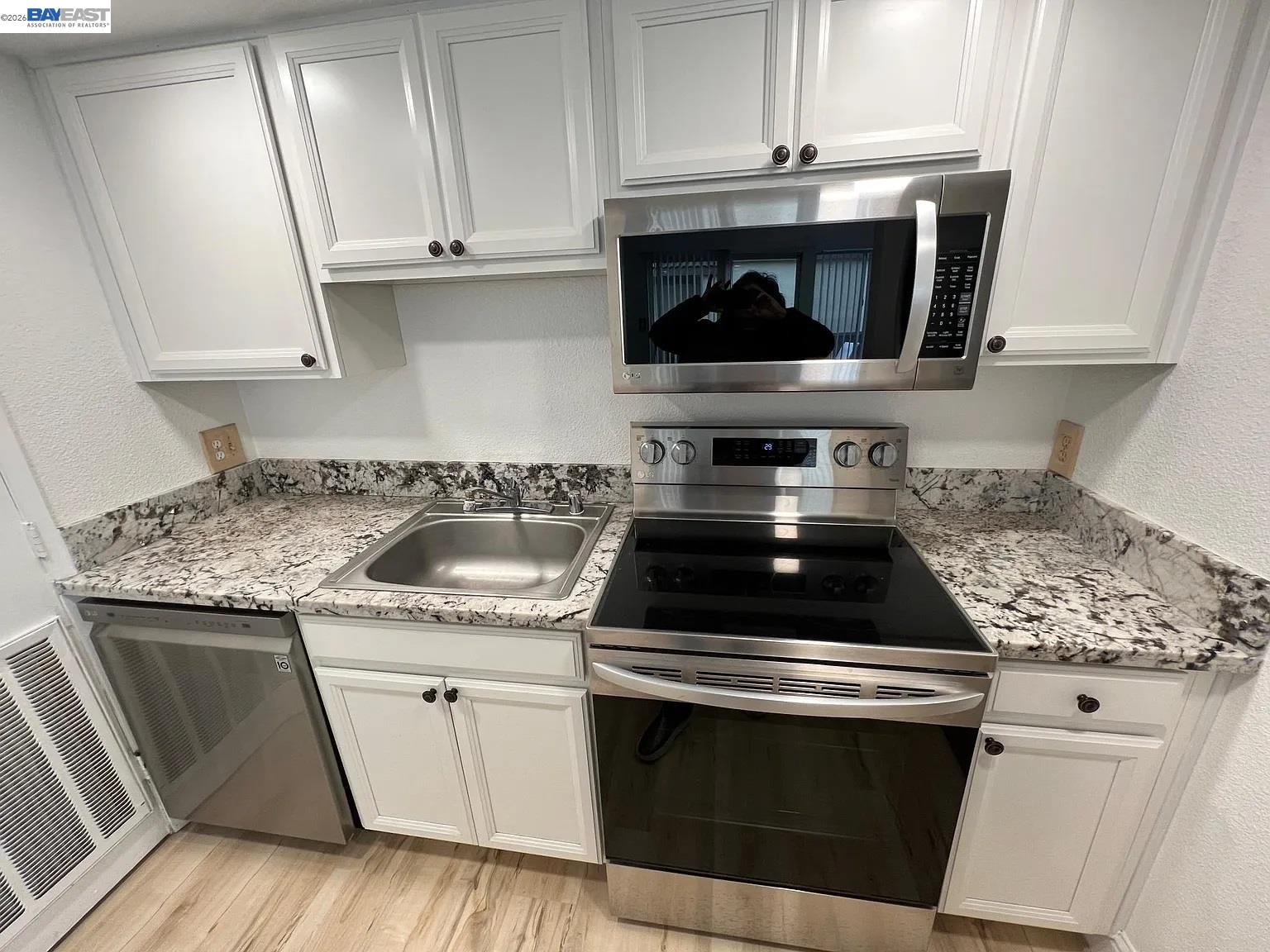 3701 Colonial Drive, Unit 36 Modesto, CA 95356 - Photo 10 of 36 a kitchen with granite countertop white cabinets and white stove