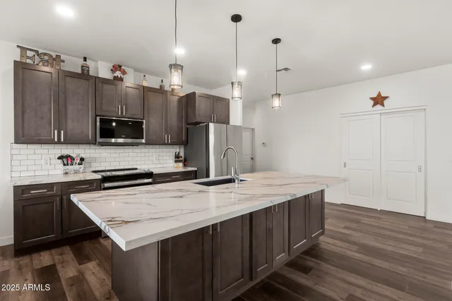 a kitchen with a sink a microwave a stove and refrigerator