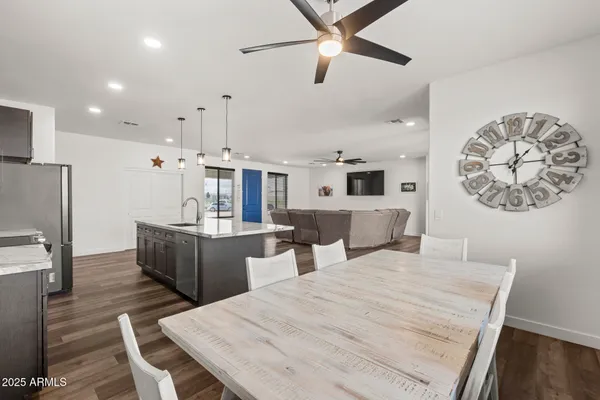 a large white kitchen with a table and chairs