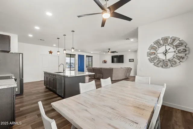 a large white kitchen with a table and chairs