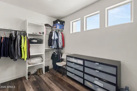 a view of walk in closet with clothes and shoes