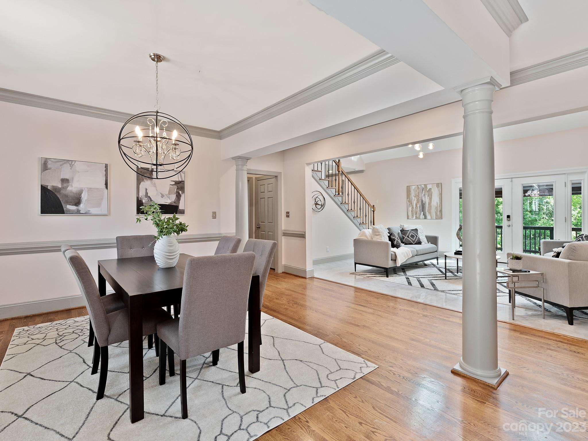 684 Beacon Knoll Lane Fort Mill, SC 29708 - Photo 11 of 46 a view of a dining room and livingroom with furniture wooden floor a chandelier