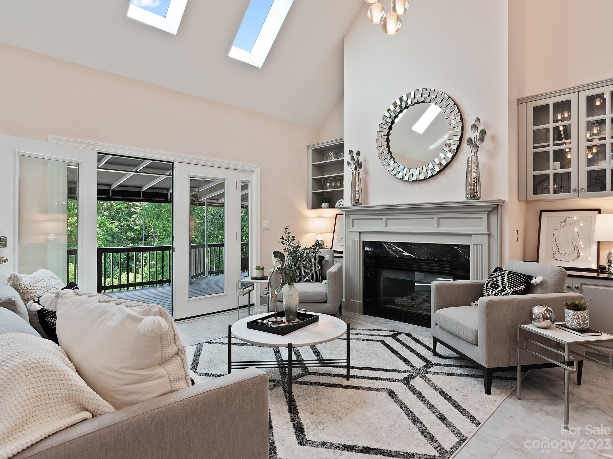 684 Beacon Knoll Lane Fort Mill, SC 29708 - Photo 12 of 46 a living room with furniture a large window and a fireplace