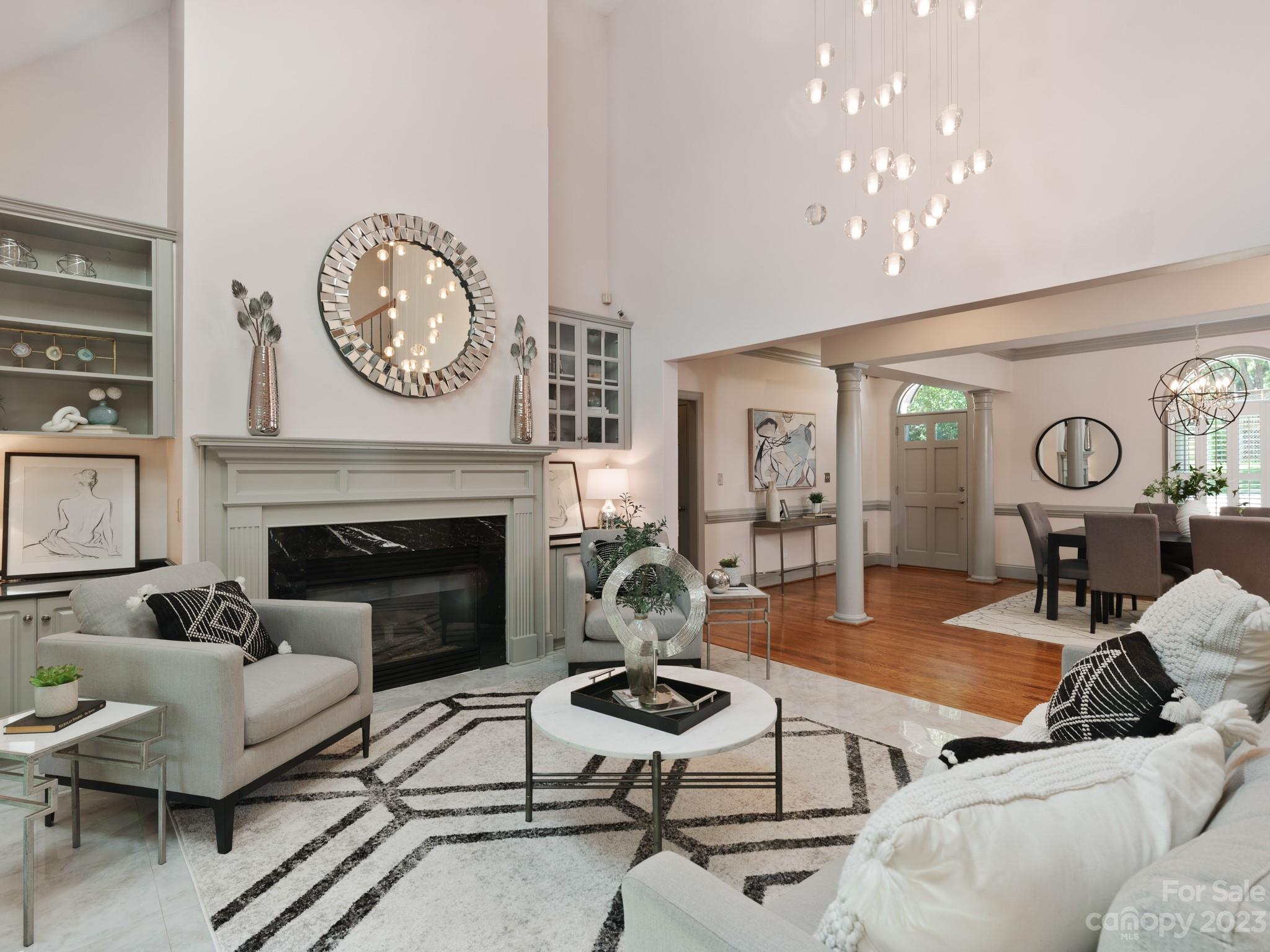 684 Beacon Knoll Lane Fort Mill, SC 29708 - Photo 13 of 46 a living room with furniture a clock and a fireplace