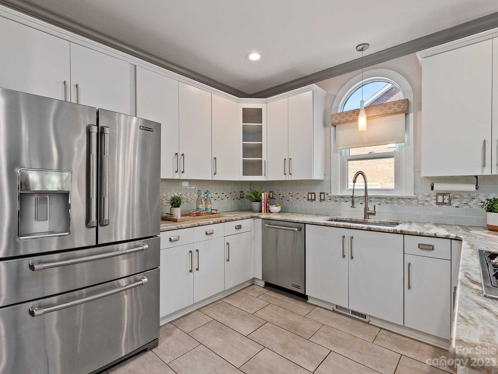 684 Beacon Knoll Lane Fort Mill, SC 29708 - Photo 19 of 46 a kitchen with granite countertop stainless steel appliances a sink and a refrigerator