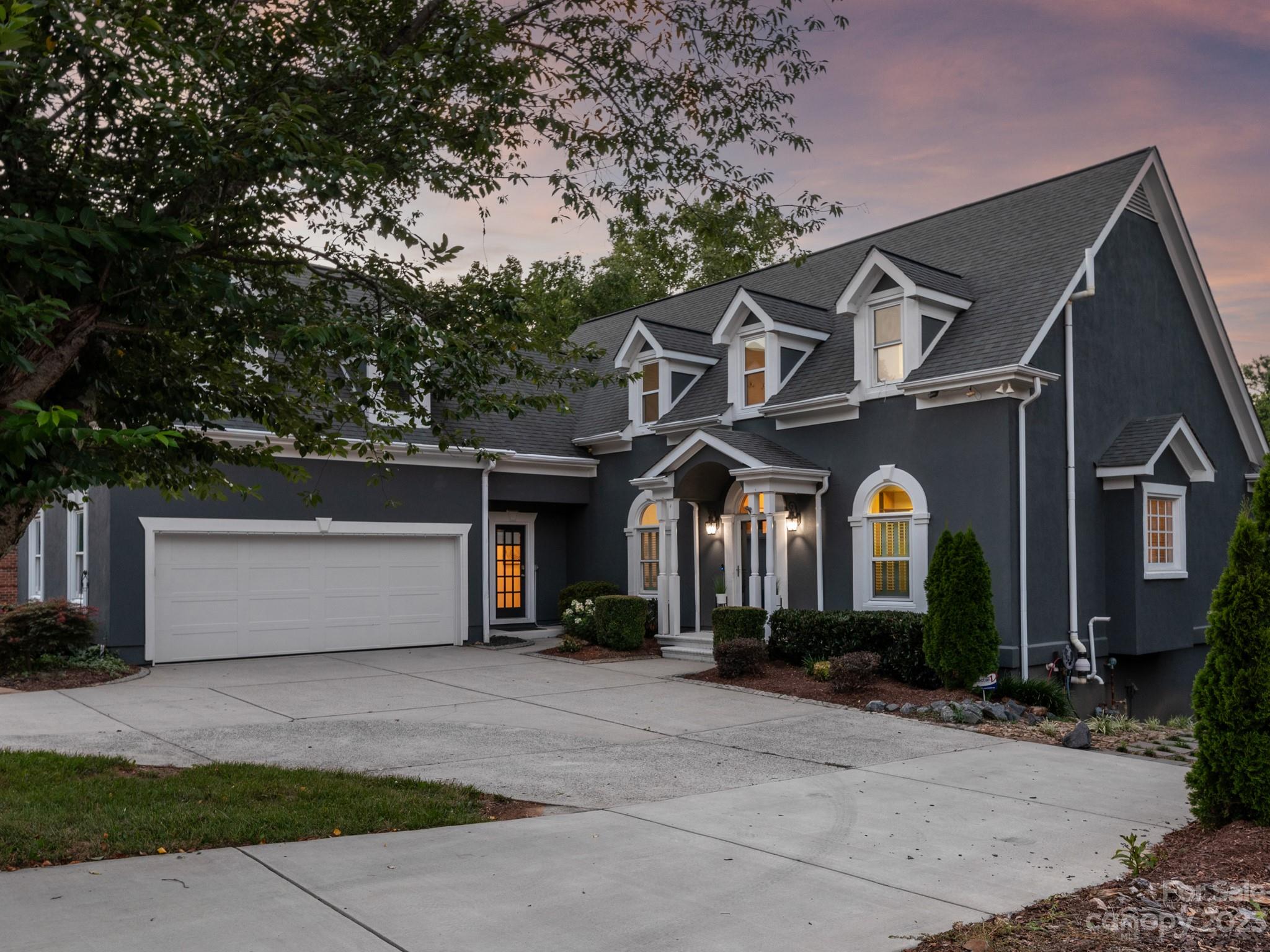 684 Beacon Knoll Lane Fort Mill, SC 29708 - Photo 2 of 46 a front view of a house with a yard and garage