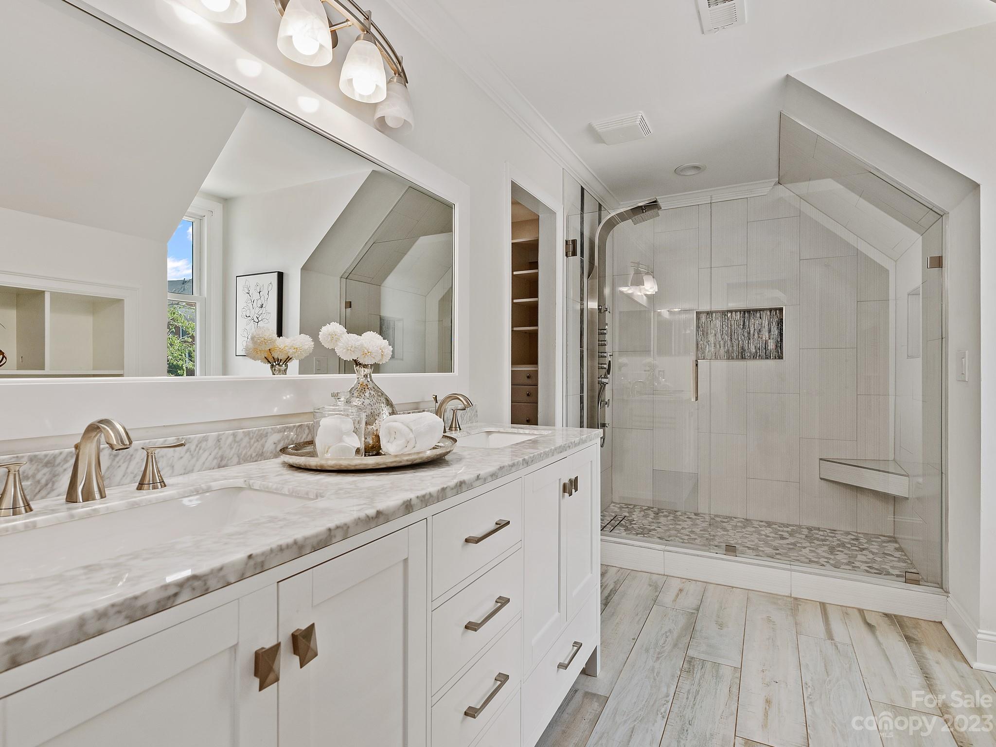 684 Beacon Knoll Lane Fort Mill, SC 29708 - Photo 23 of 46 a bathroom with a granite countertop sink a mirror and a shower