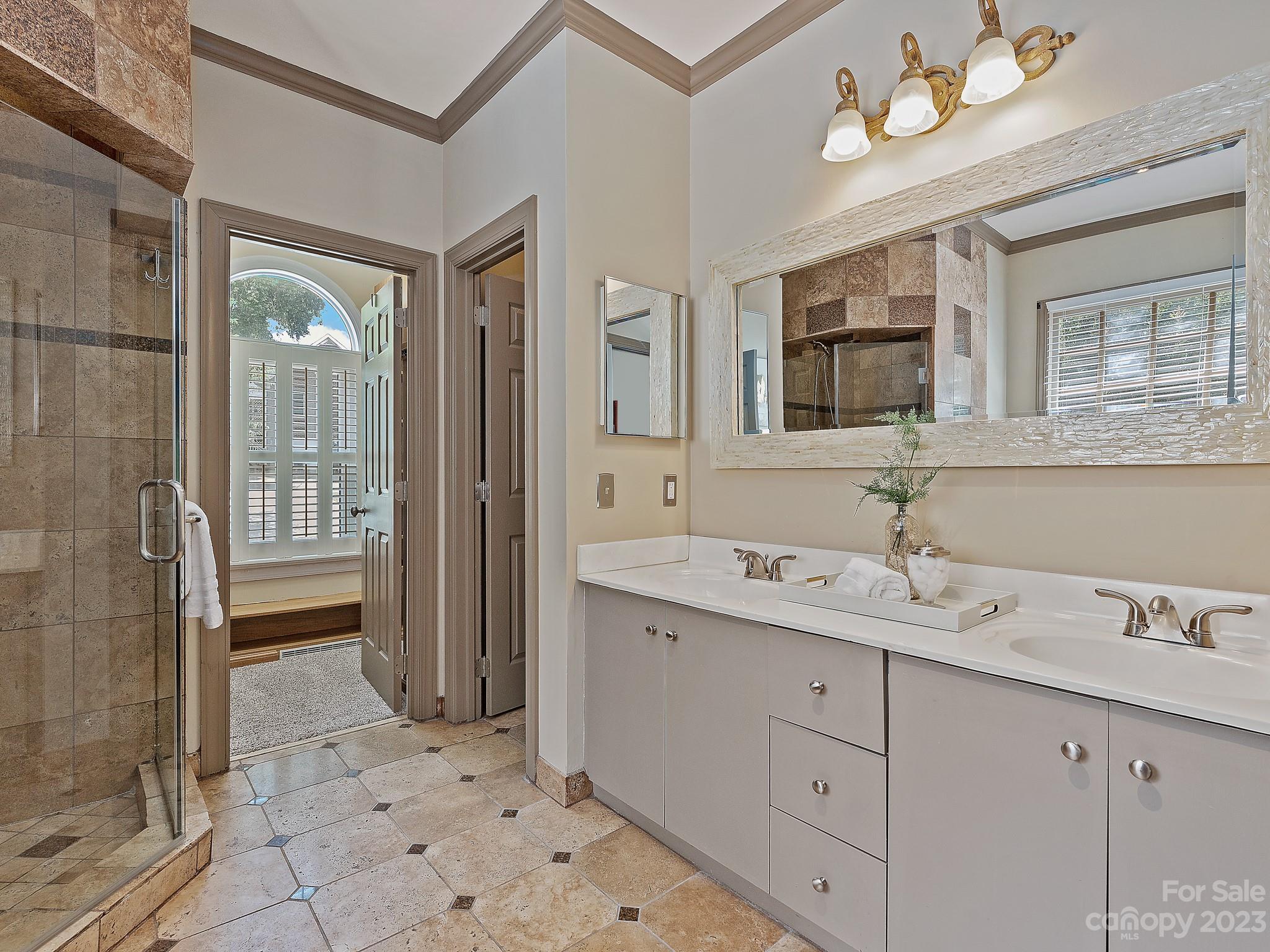 684 Beacon Knoll Lane Fort Mill, SC 29708 - Photo 26 of 46 a spacious bathroom with a double vanity sink a mirror and a shower