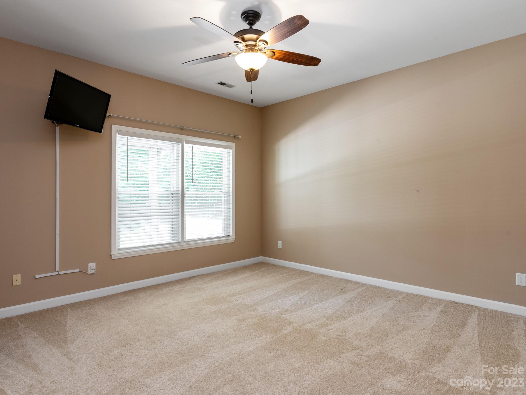684 Beacon Knoll Lane Fort Mill, SC 29708 - Photo 33 of 46 an empty room with windows and fan