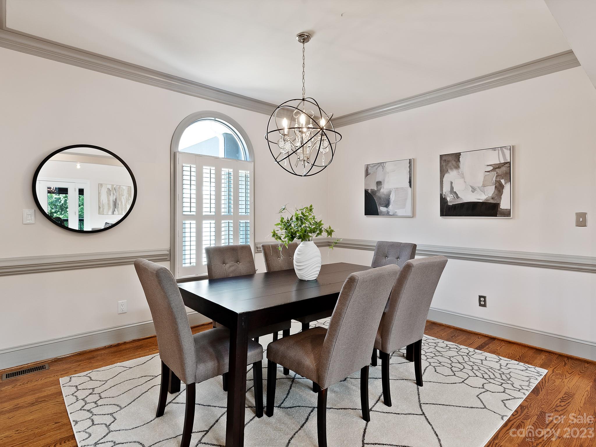684 Beacon Knoll Lane Fort Mill, SC 29708 - Photo 10 of 46 a view of a dining room with furniture a chandelier and wooden floor