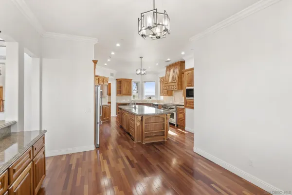 a kitchen with counter top space a sink appliances and living room view