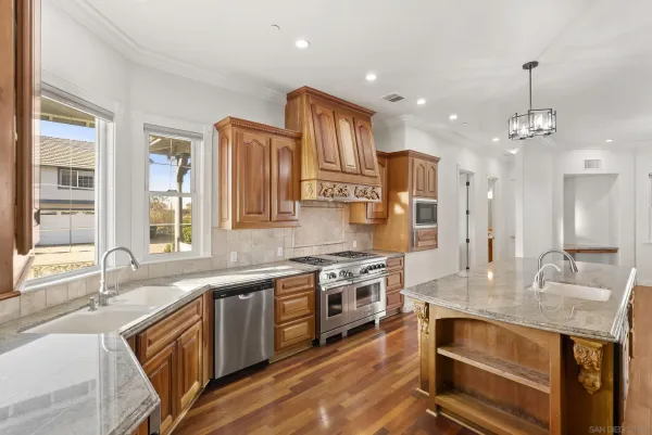 a kitchen with a sink and a stove top oven
