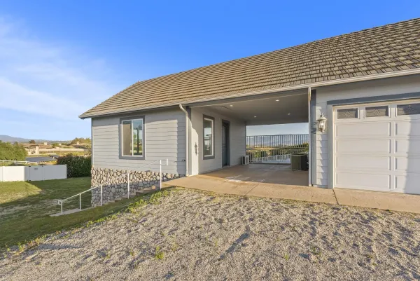 a view of a house with backyard and sitting area
