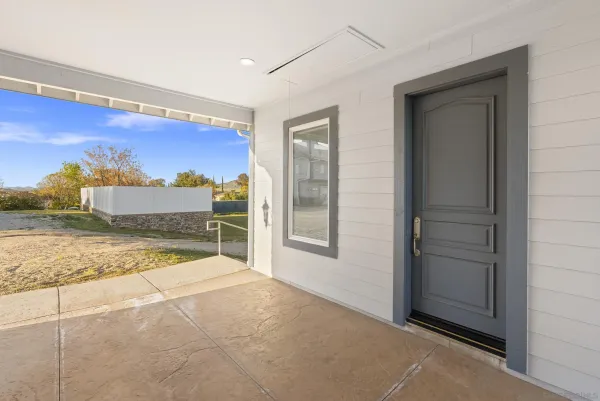an empty room with wooden floor and a window