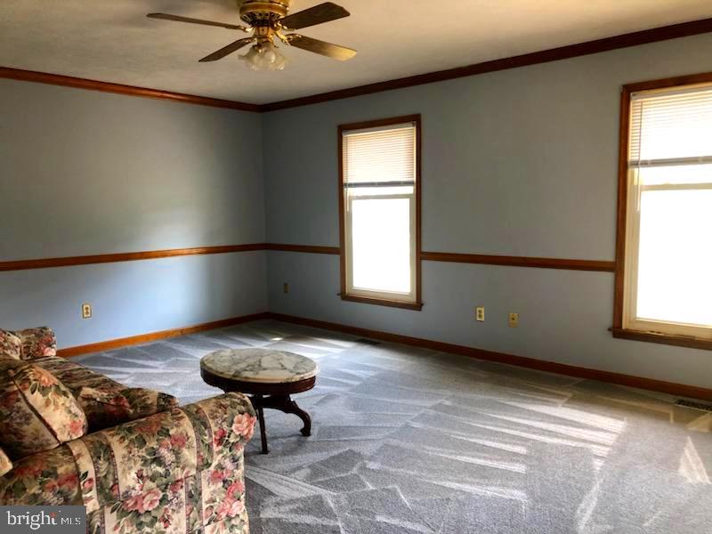 181 Grove Farm Road Front Royal, VA 22630 - Photo 16 of 35 a living room with a couch a rug and a window