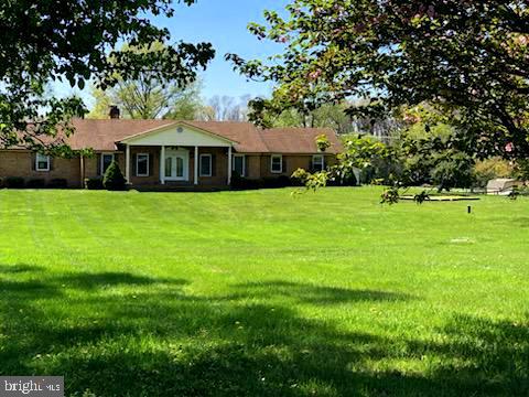 181 Grove Farm Road Front Royal, VA 22630 - Photo 5 of 35 a front view of a house with a garden