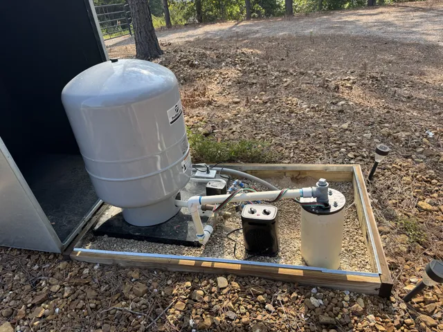 an aerial view of a house with a yard and large trees