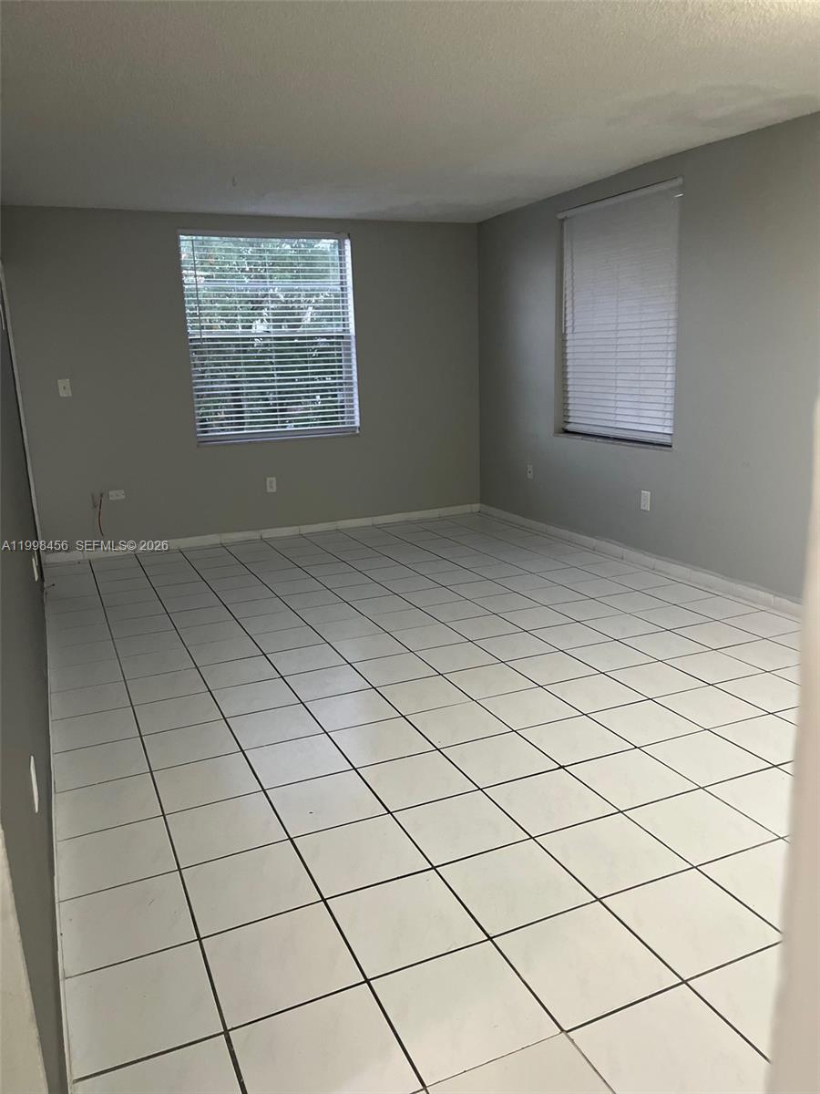 5625 West 20th Avenue, Unit 306 Hialeah, FL 33012 - Photo 1 of 9 a view of an empty room and a window