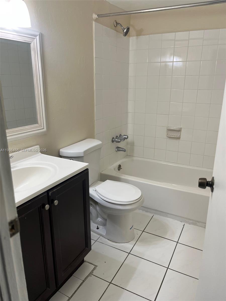5625 West 20th Avenue, Unit 306 Hialeah, FL 33012 - Photo 7 of 9 a bathroom with a sink a toilet and shower