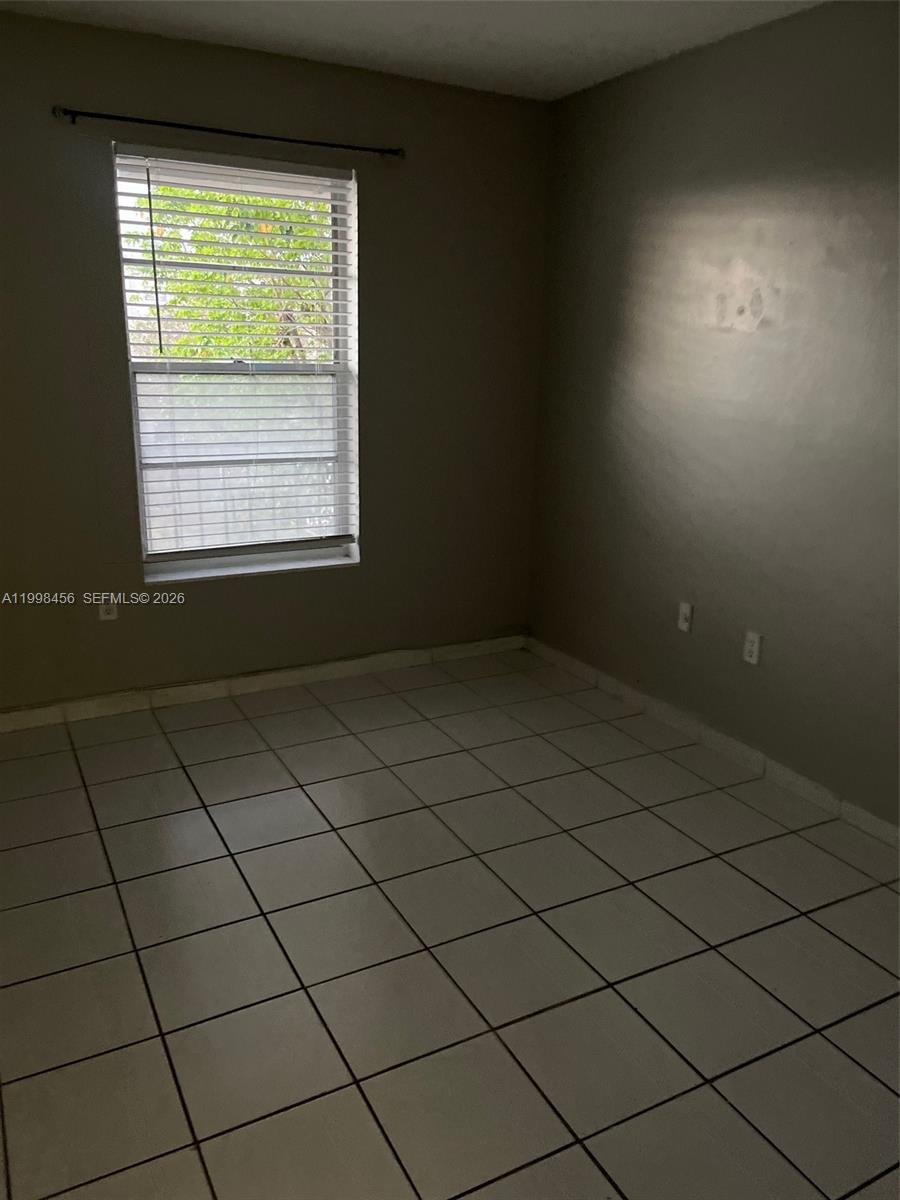 5625 West 20th Avenue, Unit 306 Hialeah, FL 33012 - Photo 8 of 9 a view of a room and window