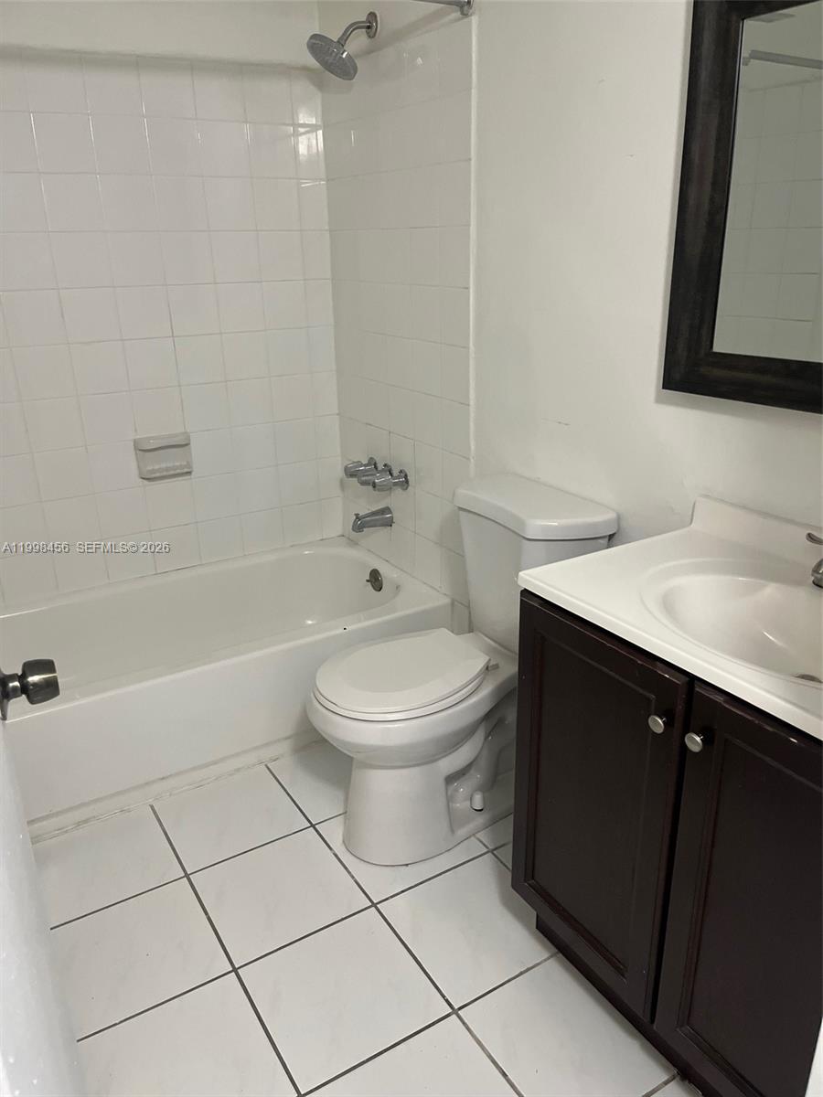5625 West 20th Avenue, Unit 306 Hialeah, FL 33012 - Photo 9 of 9 a bathroom with a sink a toilet and shower