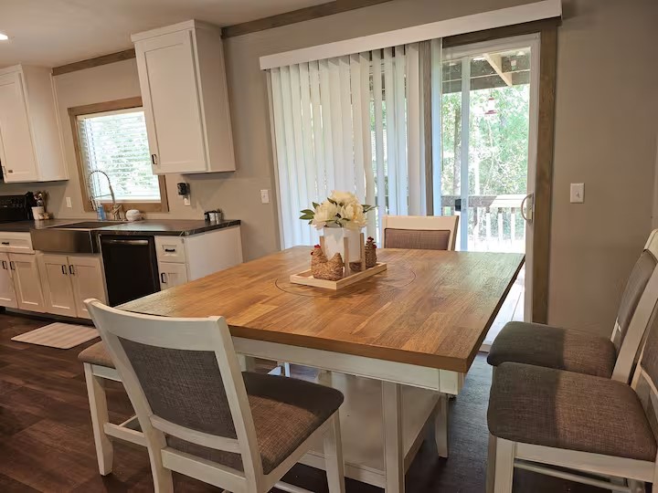 105 Saddle Surrey Road Coldspring, TX 77331 - Photo 24 of 48 a kitchen with a table chairs sink and cabinets