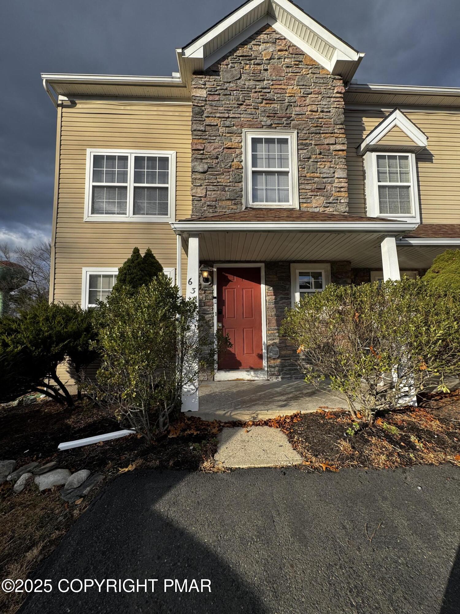 63 Ridgeview Circle, Unit A East Stroudsburg, PA 18302 - Photo 1 of 13 a front view of a house with a yard