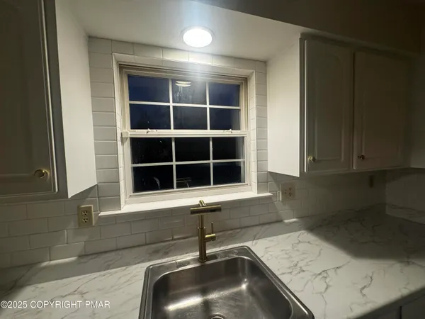 a bathroom with a sink and a window