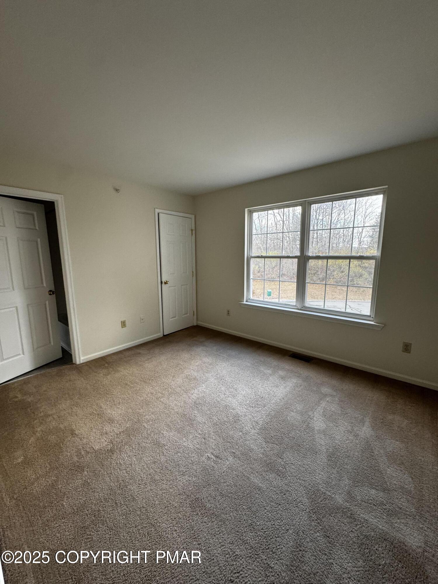 63 Ridgeview Circle, Unit A East Stroudsburg, PA 18302 - Photo 8 of 13 an empty room with a window