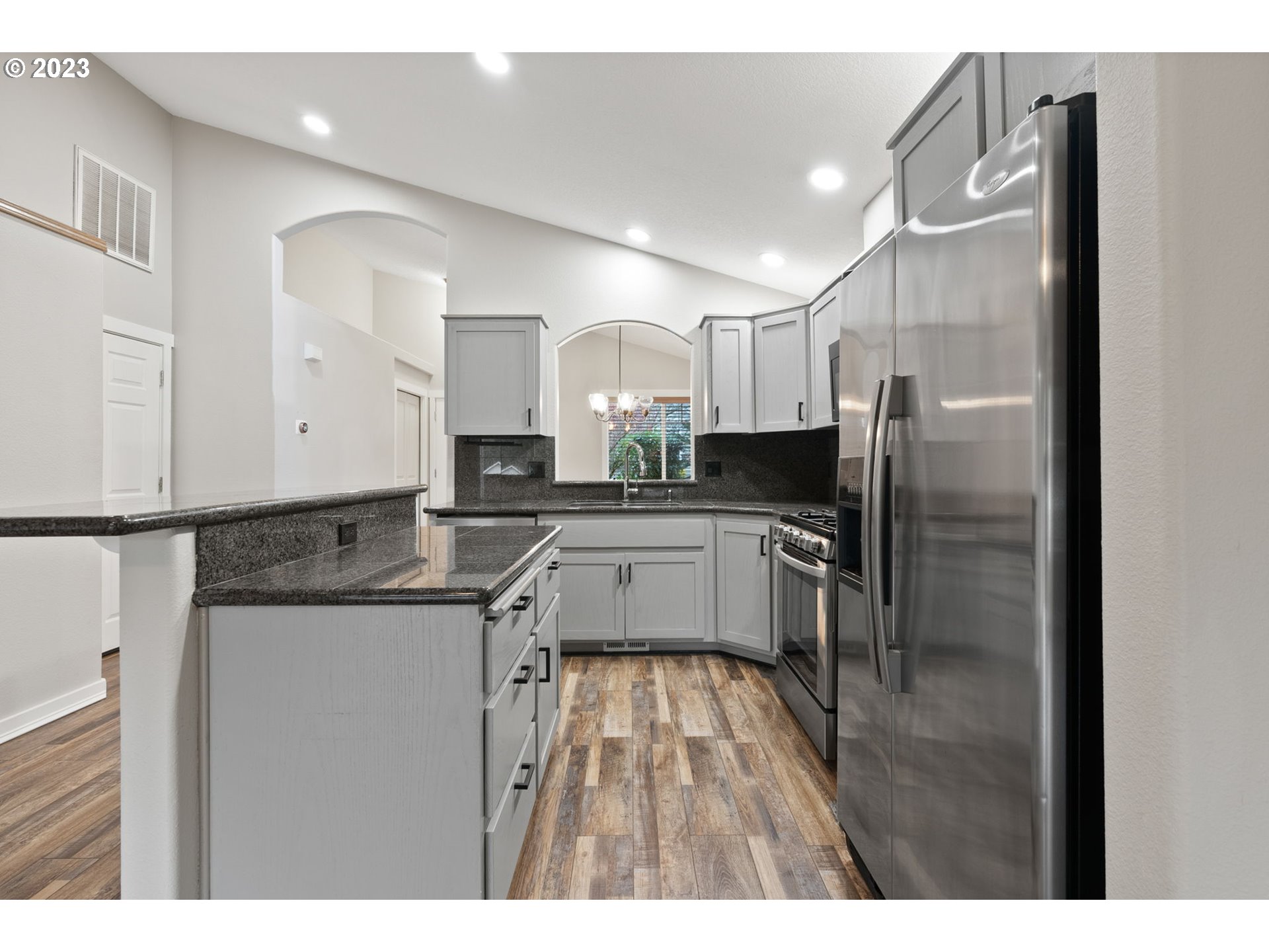 38446 Miller Street Sandy, OR 97055 - Photo 11 of 40 a kitchen with granite countertop a refrigerator a sink a stove and cabinets