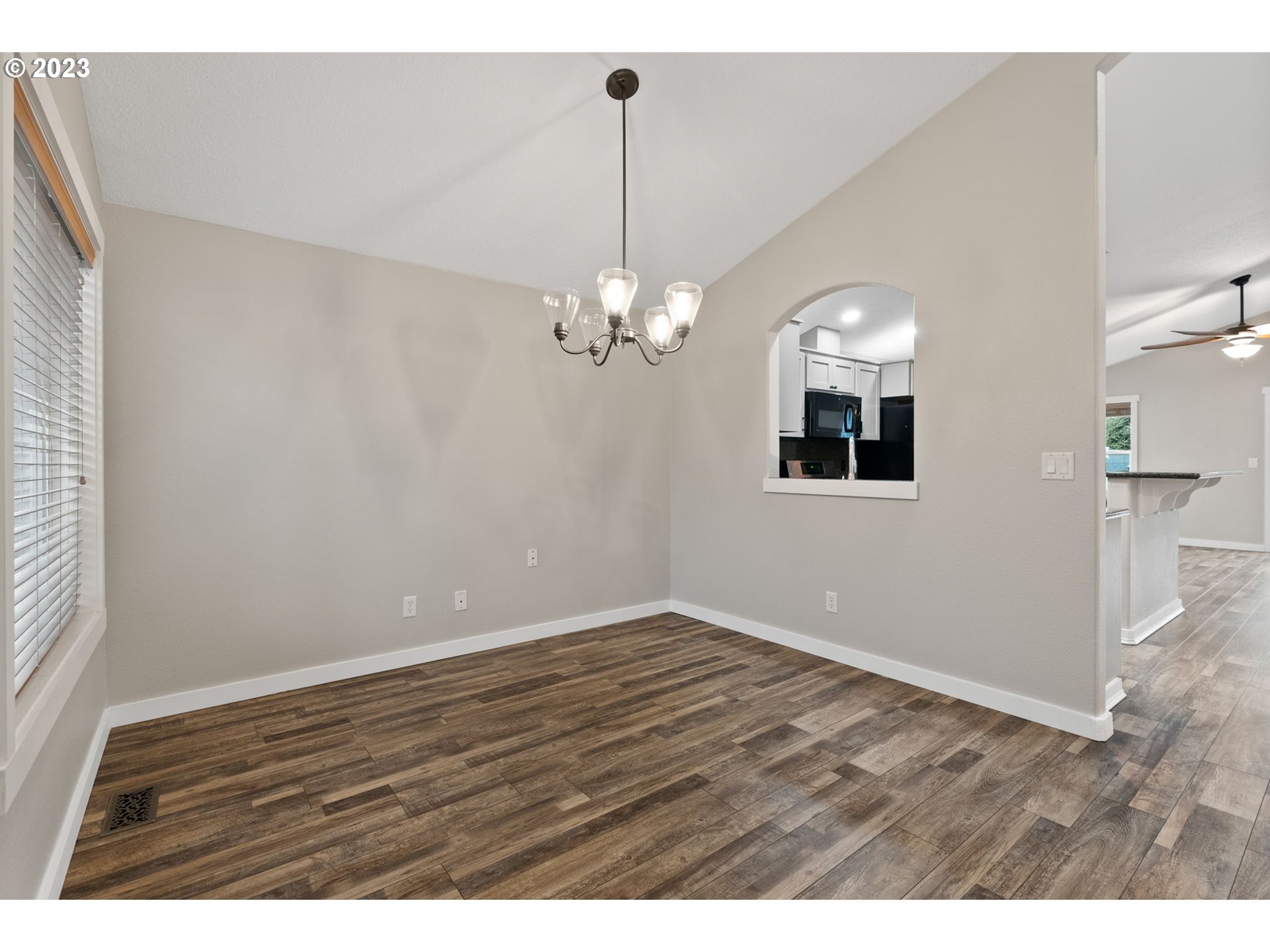 38446 Miller Street Sandy, OR 97055 - Photo 7 of 40 a view of a room with wooden floor and chandelier