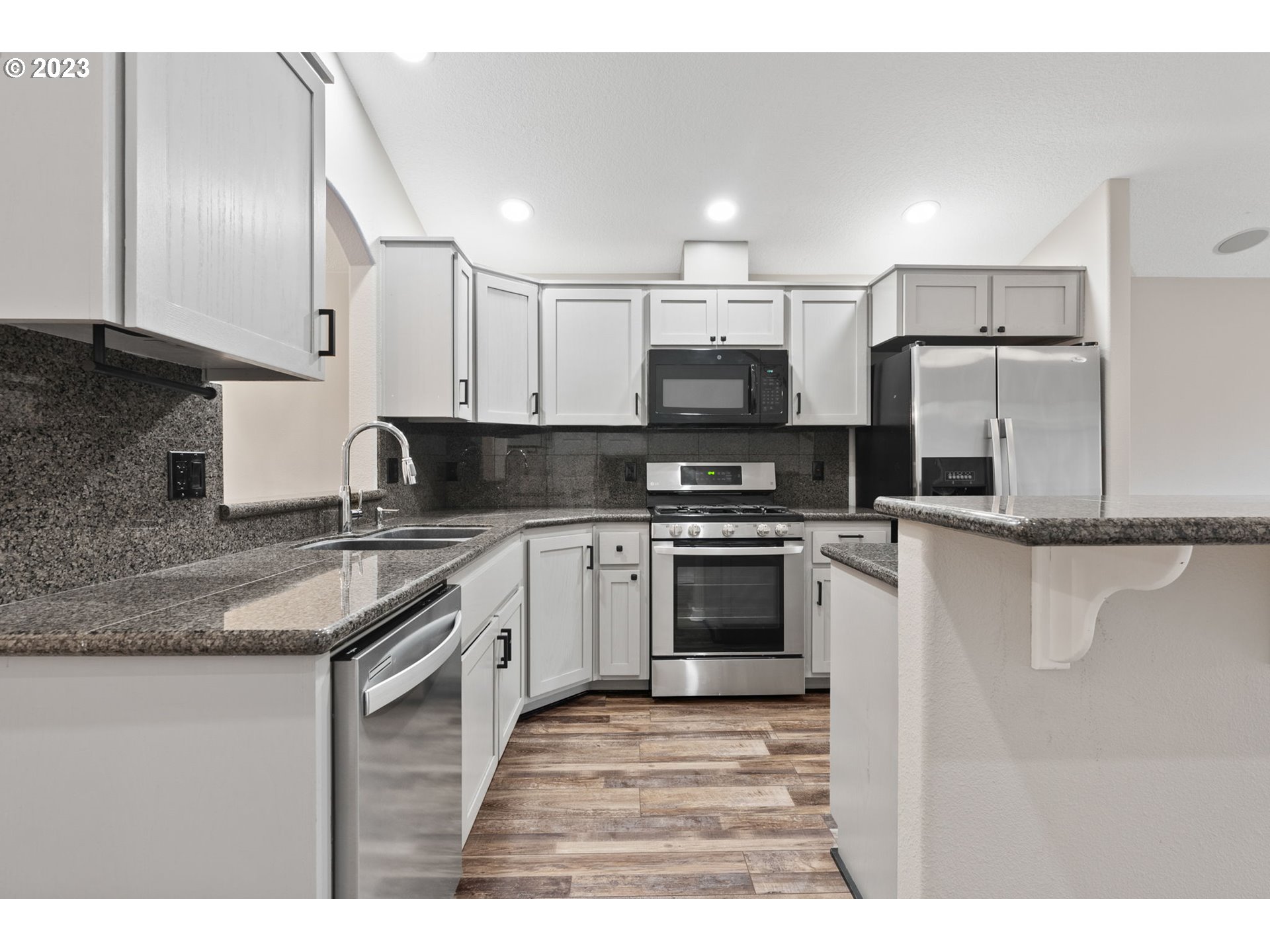 38446 Miller Street Sandy, OR 97055 - Photo 9 of 40 a kitchen with kitchen island a sink stainless steel appliances and cabinets