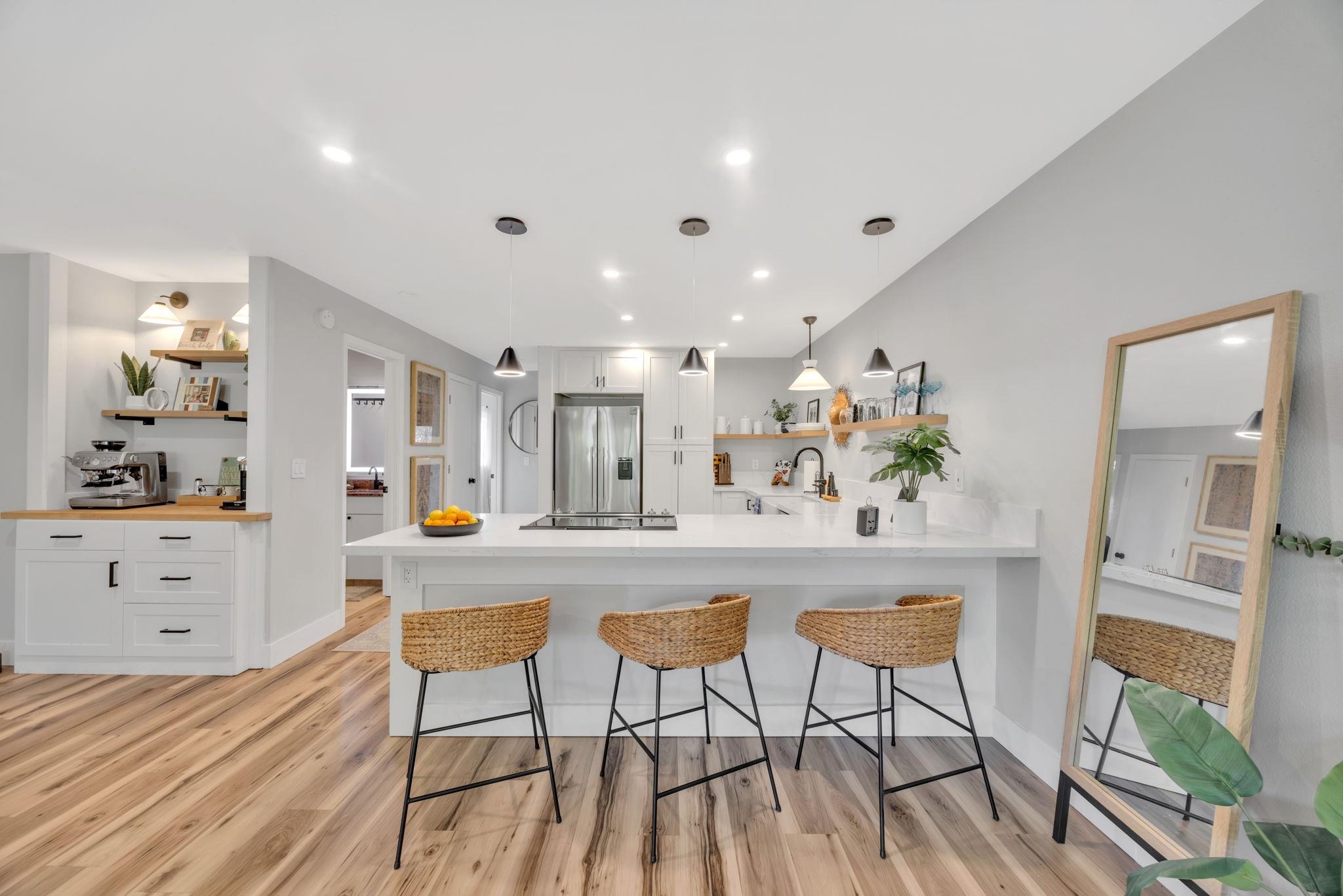 1450 South Kihei Road, Unit C206 Kihei, HI 96753 - Photo 16 of 50 a view of a white kitchen with table and chairs