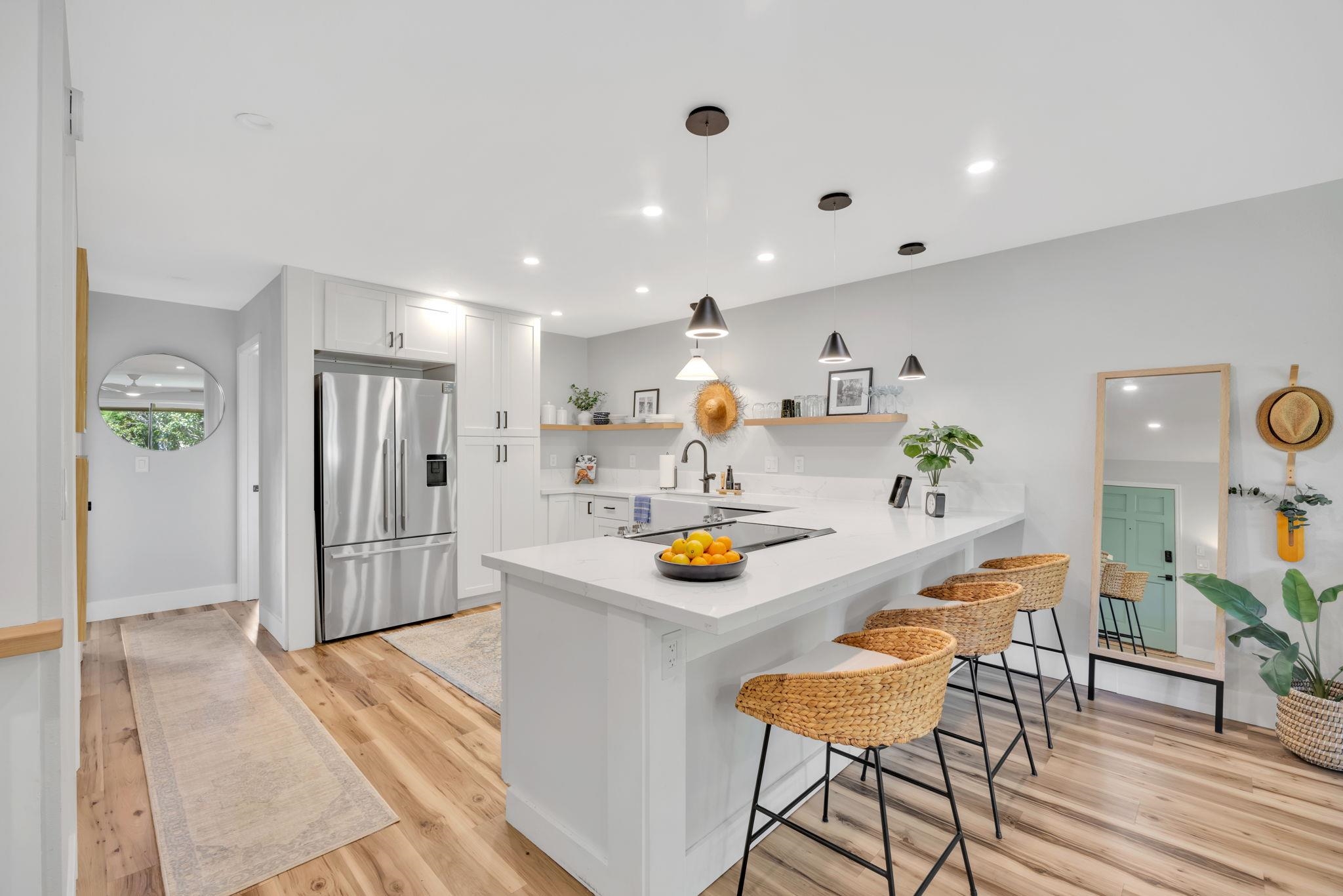 1450 South Kihei Road, Unit C206 Kihei, HI 96753 - Photo 2 of 50 a kitchen with stainless steel appliances kitchen island granite countertop a refrigerator and a sink