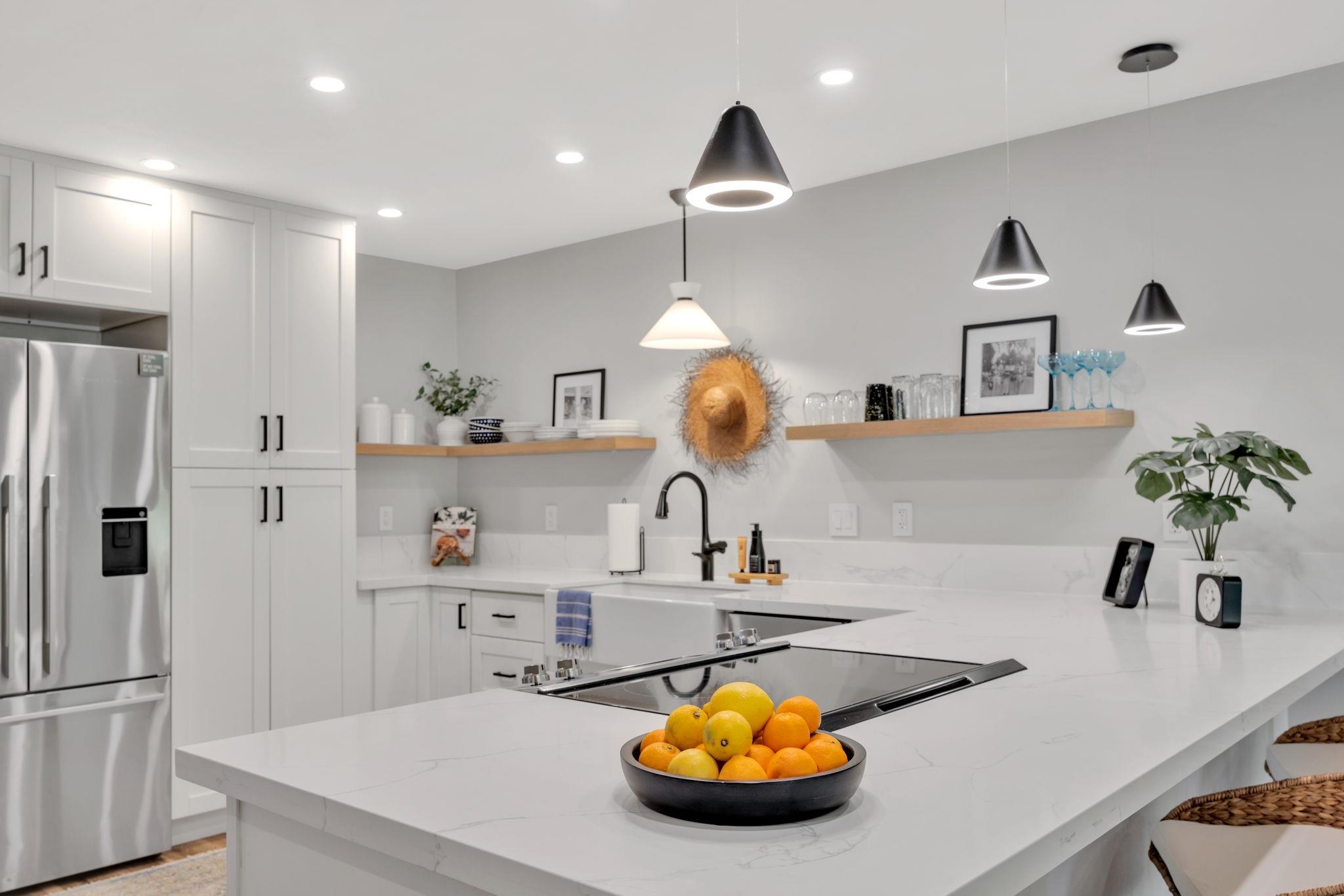 1450 South Kihei Road, Unit C206 Kihei, HI 96753 - Photo 21 of 50 a kitchen with a sink a refrigerator and cabinets