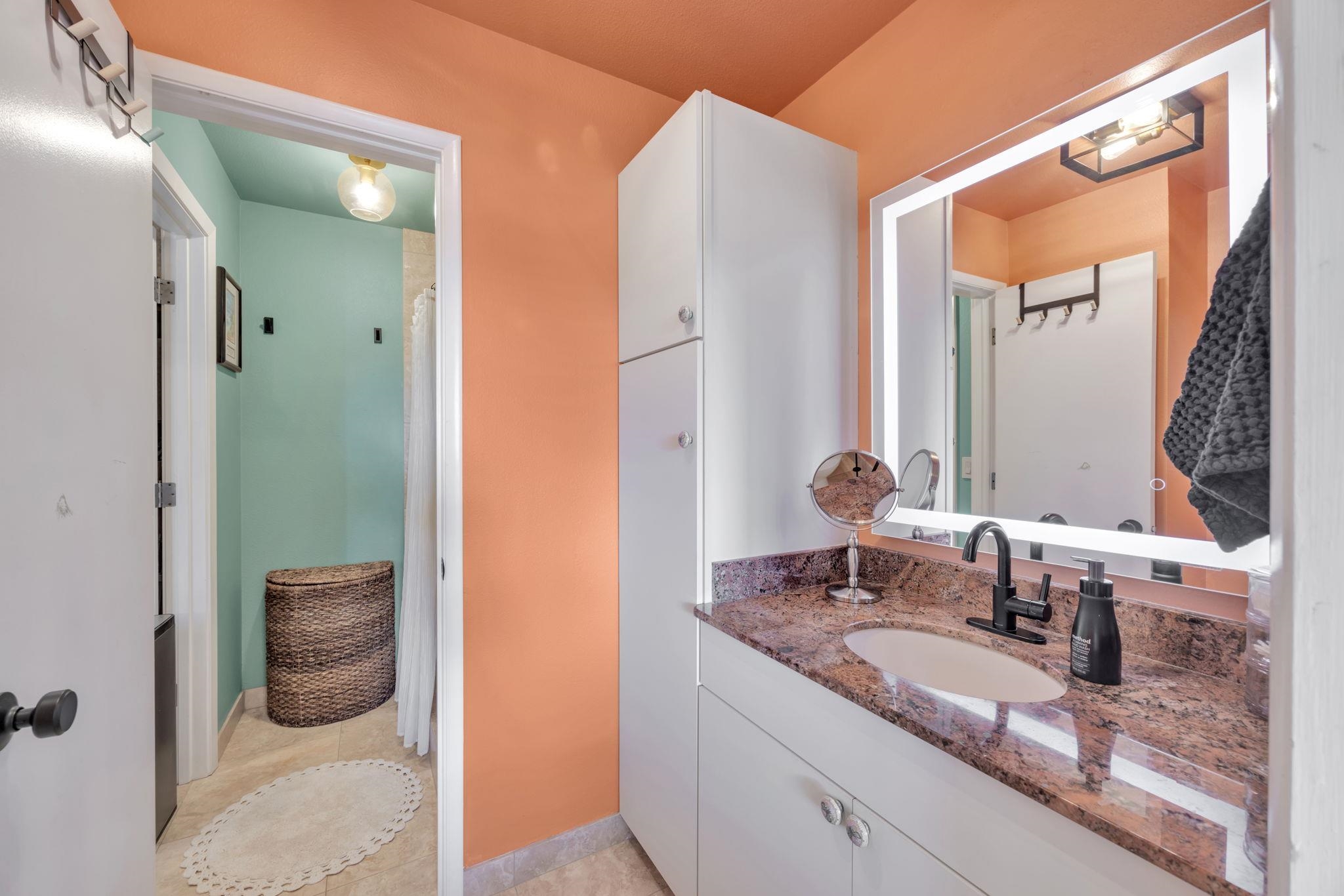 1450 South Kihei Road, Unit C206 Kihei, HI 96753 - Photo 27 of 50 a en suite bathroom with a granite countertop sink and a mirror