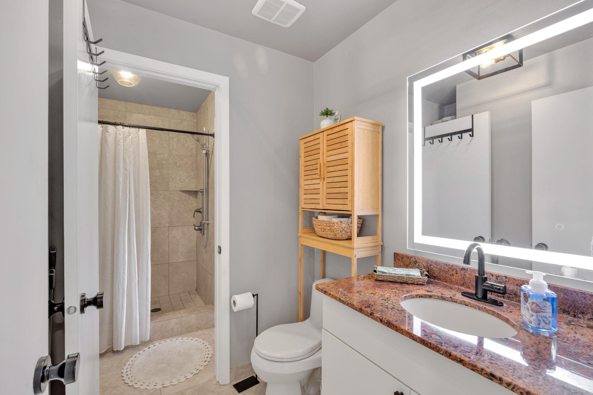 1450 South Kihei Road, Unit C206 Kihei, HI 96753 - Photo 29 of 50 a bathroom with a granite countertop sink toilet a mirror and shower