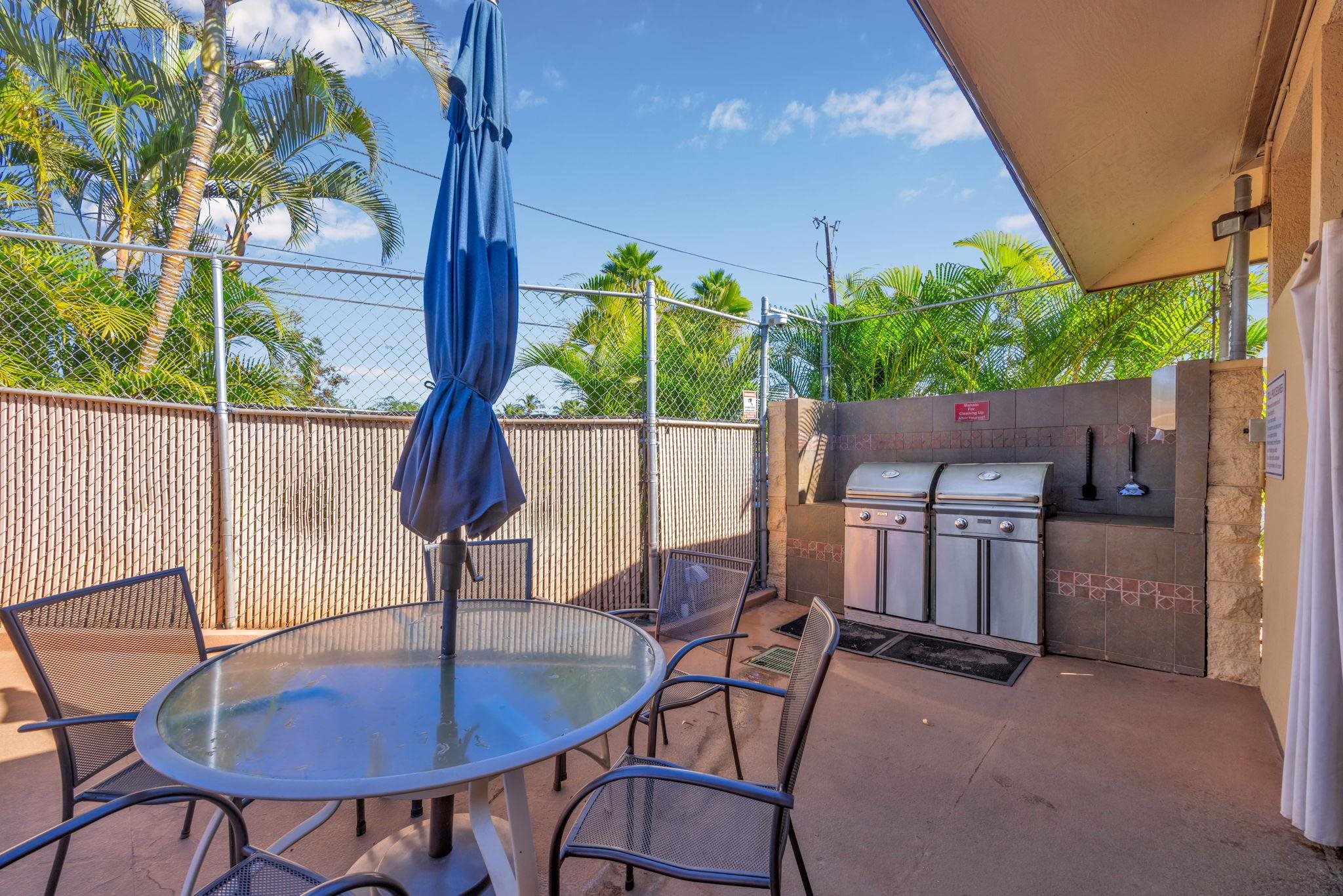 1450 South Kihei Road, Unit C206 Kihei, HI 96753 - Photo 47 of 50 a backyard of a house with table and chairs