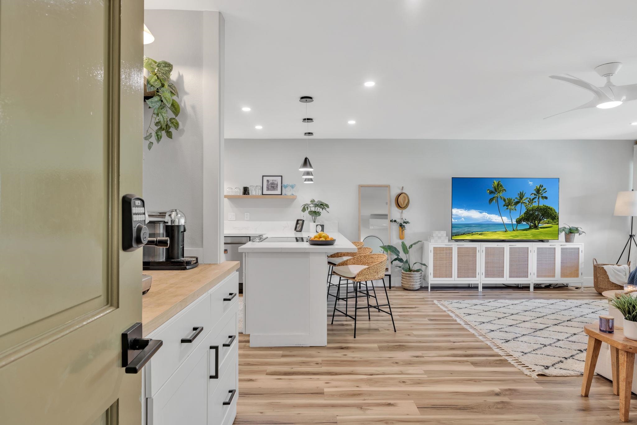 1450 South Kihei Road, Unit C206 Kihei, HI 96753 - Photo 7 of 50 a view of a dining room with furniture and wooden floor