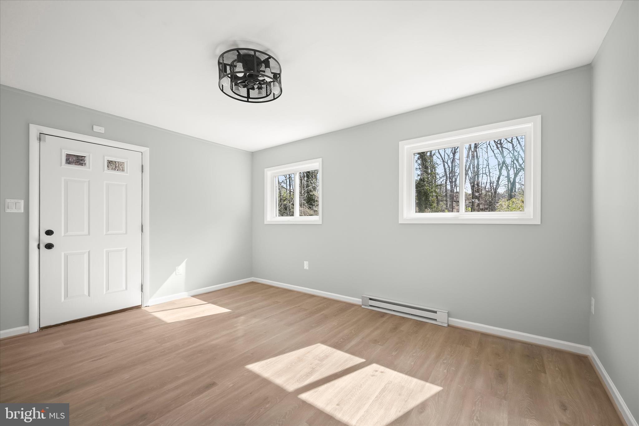 9720 Hedin Drive Silver Spring, MD 20903 - Photo 59 of 79 a view of an empty room with wooden floor and a window