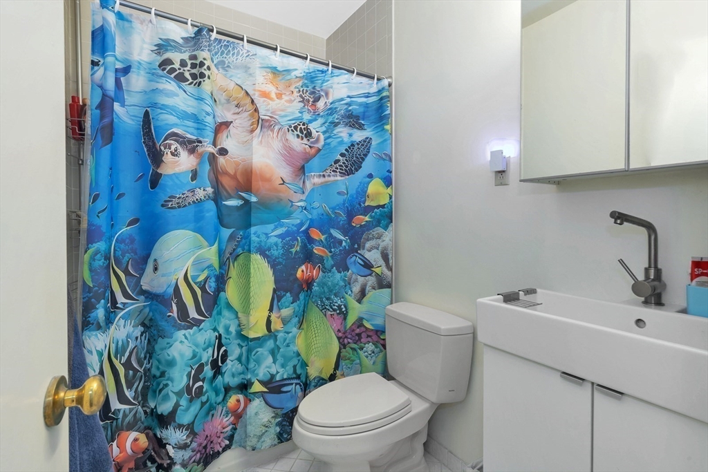 33 Brainerd Road, Unit 311 Boston, MA 02134 - Photo 14 of 18 a bathroom with a toilet sink and mirror