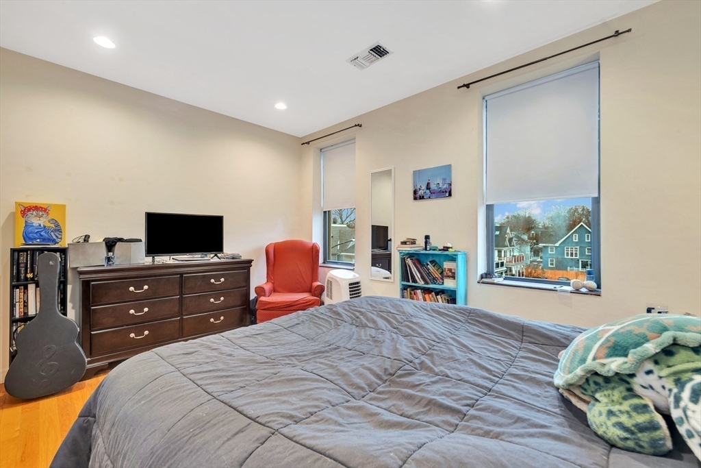33 Brainerd Road, Unit 311 Boston, MA 02134 - Photo 16 of 18 a bed room with a bed and a television