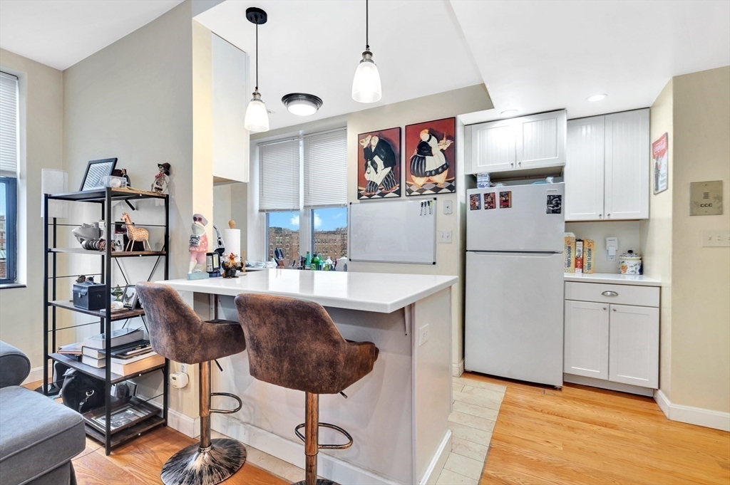 33 Brainerd Road, Unit 311 Boston, MA 02134 - Photo 6 of 18 a kitchen with white cabinets and stainless steel appliances