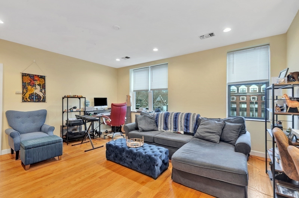33 Brainerd Road, Unit 311 Boston, MA 02134 - Photo 8 of 18 a living room with furniture and a flat screen tv