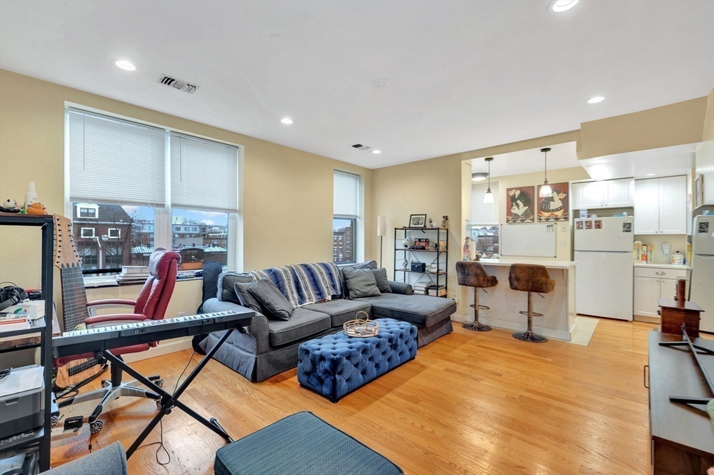 33 Brainerd Road, Unit 311 Boston, MA 02134 - Photo 10 of 18 a living room with furniture kitchen view and a wooden floor