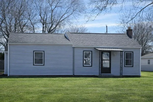 a view of a house with a backyard