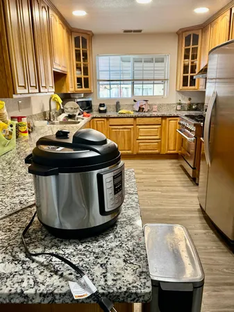 a kitchen with stainless steel appliances granite countertop a sink stove and refrigerator