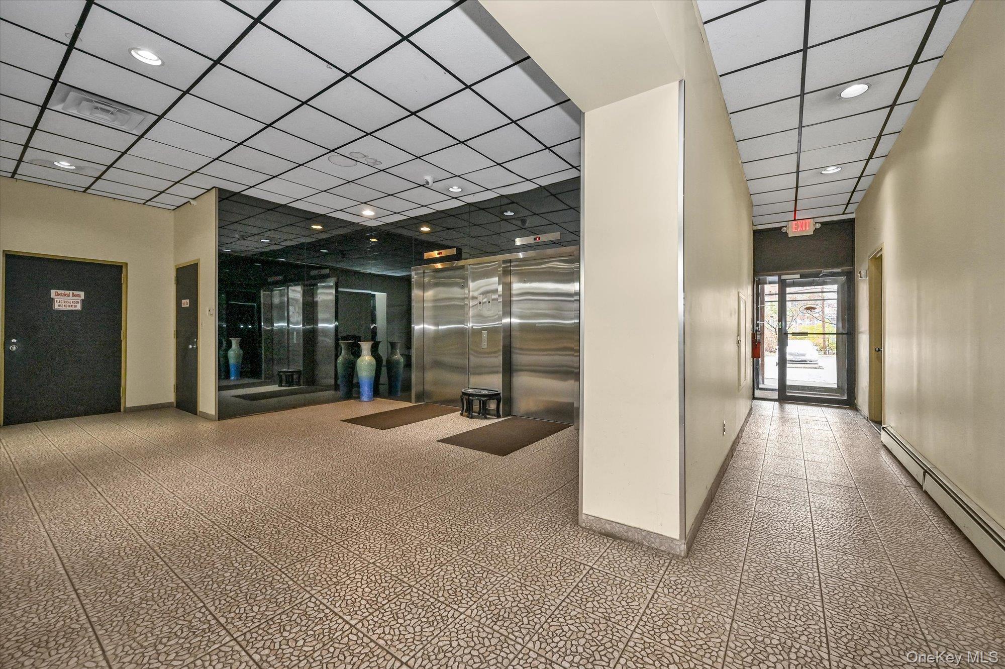 136-75 37th Avenue, Unit PH B Queens, NY 11354 - Photo 12 of 17 a view of a room with large windows