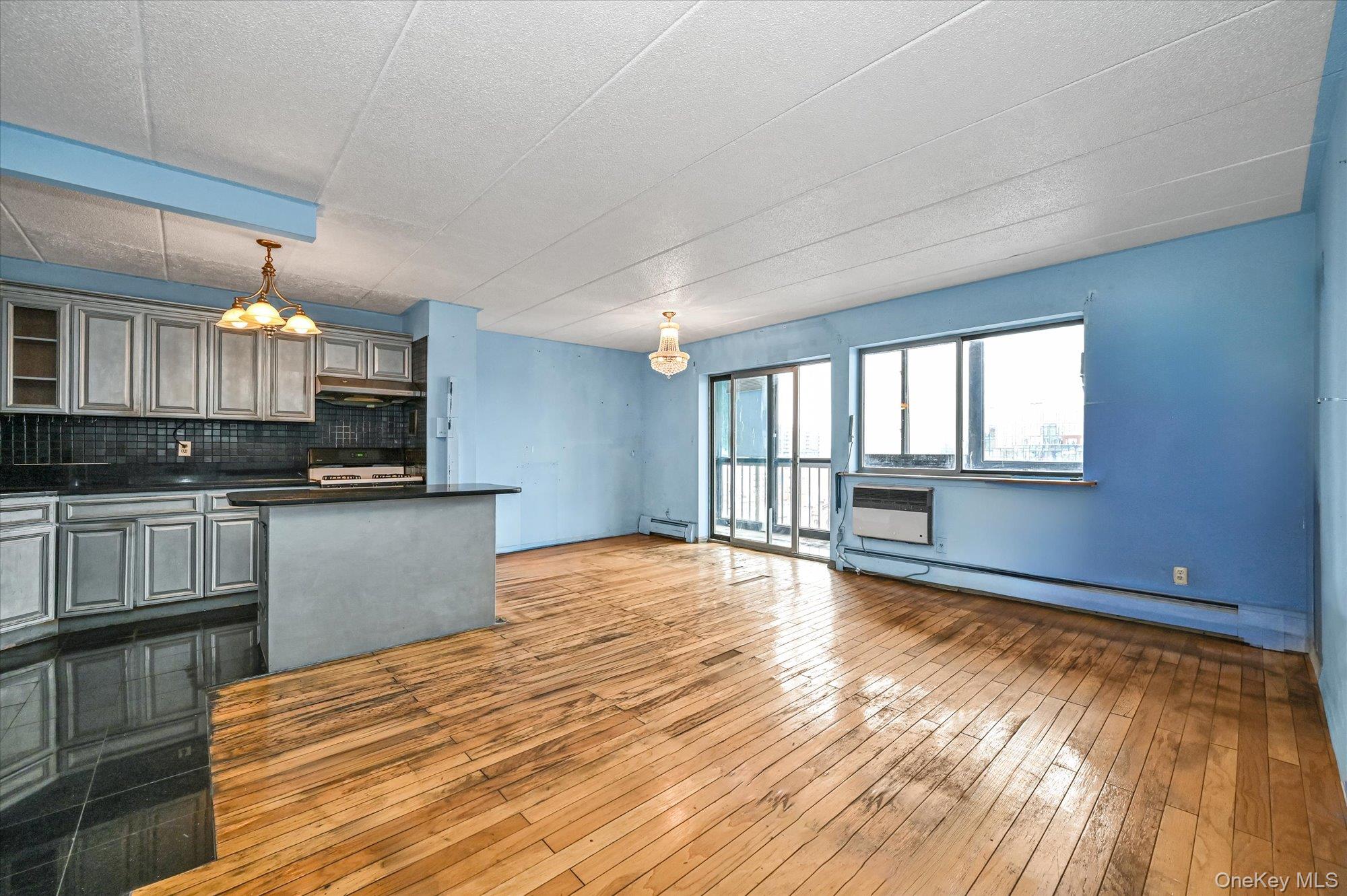136-75 37th Avenue, Unit PH B Queens, NY 11354 - Photo 5 of 17 a view of kitchen with wooden floor and electronic appliances