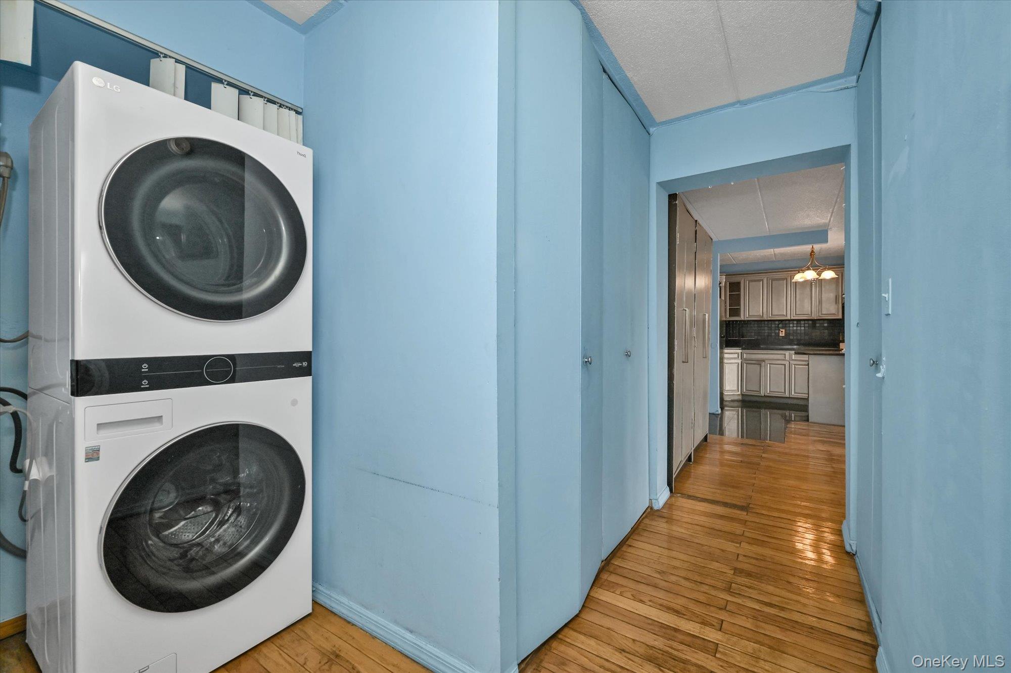 136-75 37th Avenue, Unit PH B Queens, NY 11354 - Photo 7 of 17 a view of a hallway with washer and dryer